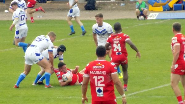 Workington roughly tackle the Doncaster ball carrier.